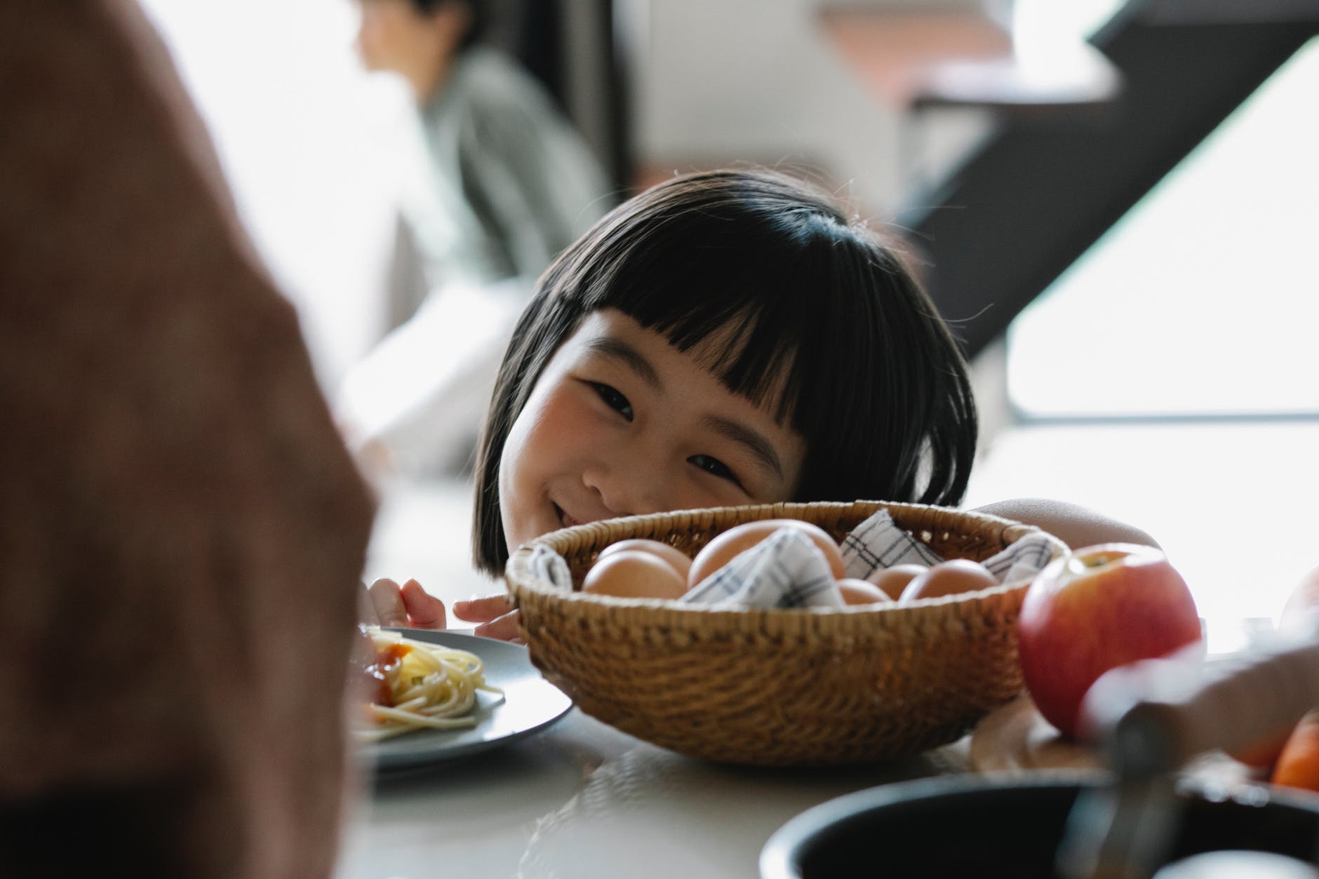 happy asian little girl in kitchen